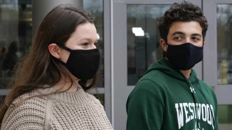 While wearing protective masks due to the COVID-19 outbreak, Lucy Vitali, who portrays Juliet, left, stands with Alex Mansour, who portrays Romeo, outside the auditorium after working on their virtual performance of Shakespeare